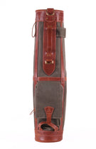 A vintage-style leather and canvas golf bag shown from the back, featuring reddish-brown leather trim and panels with a dark gray-green canvas body, photographed against a solid white background.