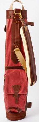 Red golf bag with brown leather accents on a white background