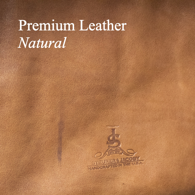 Brown leather surface with 'Studer & Jacoby' logo and text 'Premium Leather Natural'.
